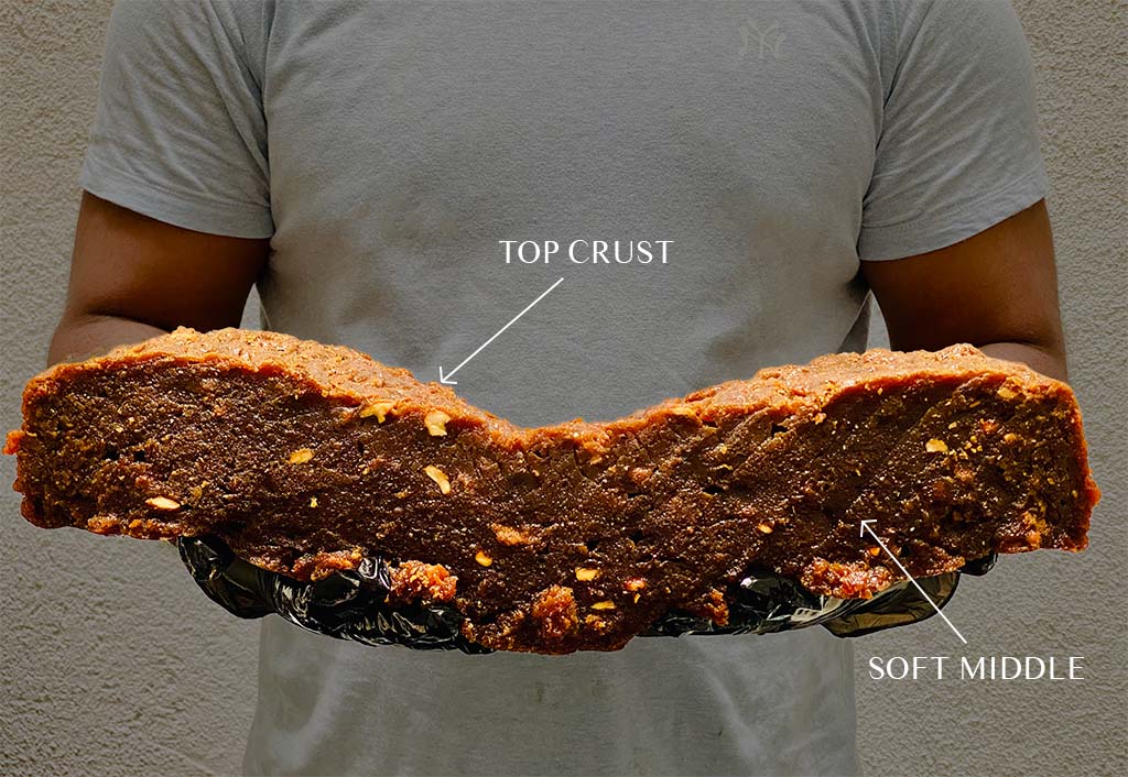 A slab of dodol showing its sweet roasted top crust and soft middle